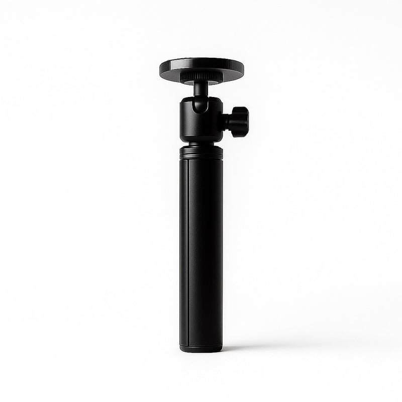 Folded black flexible stand for portable monitor with a compact cylindrical body, round mounting plate, and adjustable ball head on a clean white background.