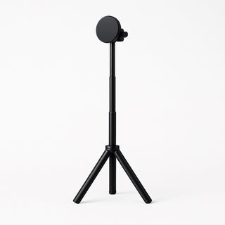 Angled front-side view of a flexible stand for portable monitor, showing the slim telescoping pole, round mount, and three tripod legs for stable desktop use.