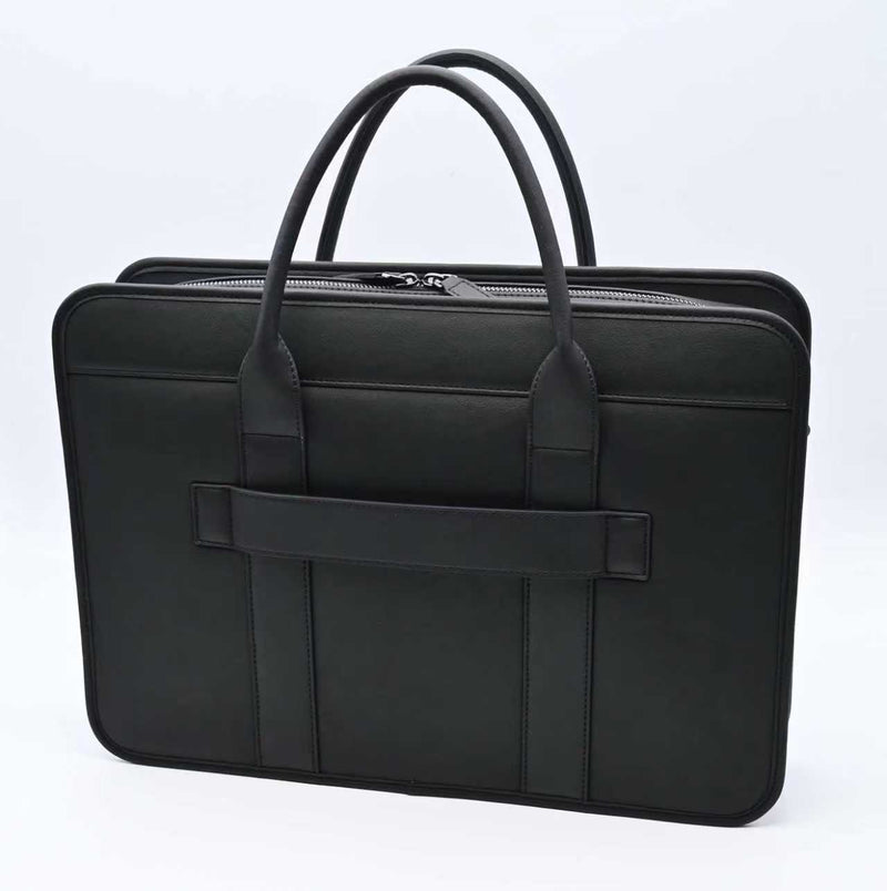 Black laptop bag shown from the back on a white background, with rounded top handles, a structured slim profile, and a horizontal back strap for travel or daily work use.