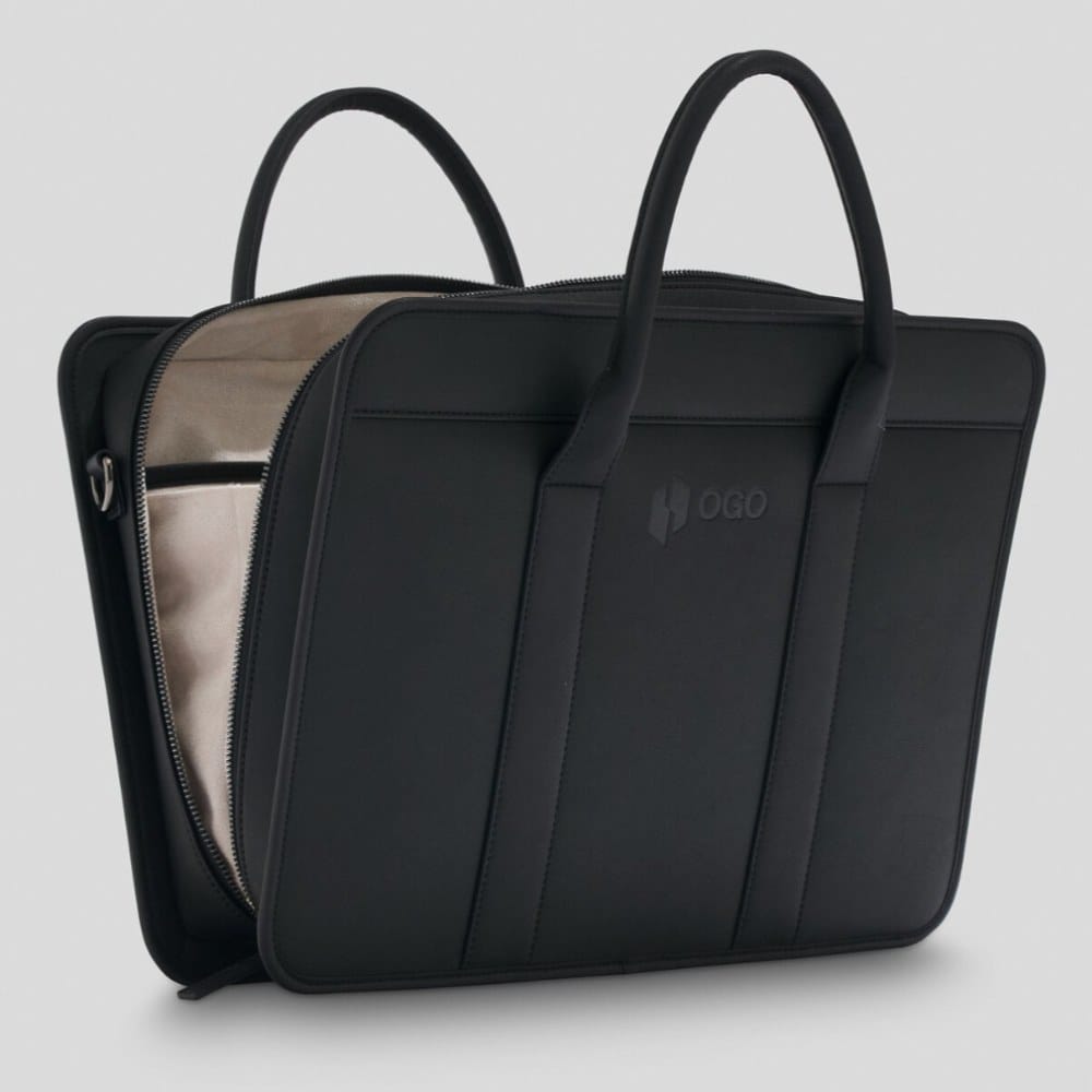 Angled side view of a black laptop bag with the zipper partly open, showing the spacious interior, sturdy construction, and minimalist design for carrying a laptop and documents.