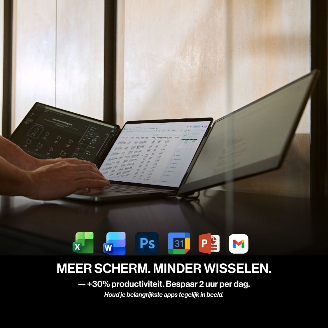 Person using a laptop with two portable monitor screens while working across multiple applications in a spacious three-display workstation.