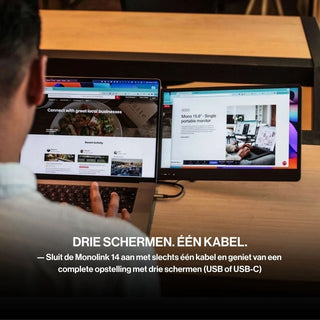 Person using a laptop with a portable monitor and two side displays, creating a three-screen workspace connected with a single cable.