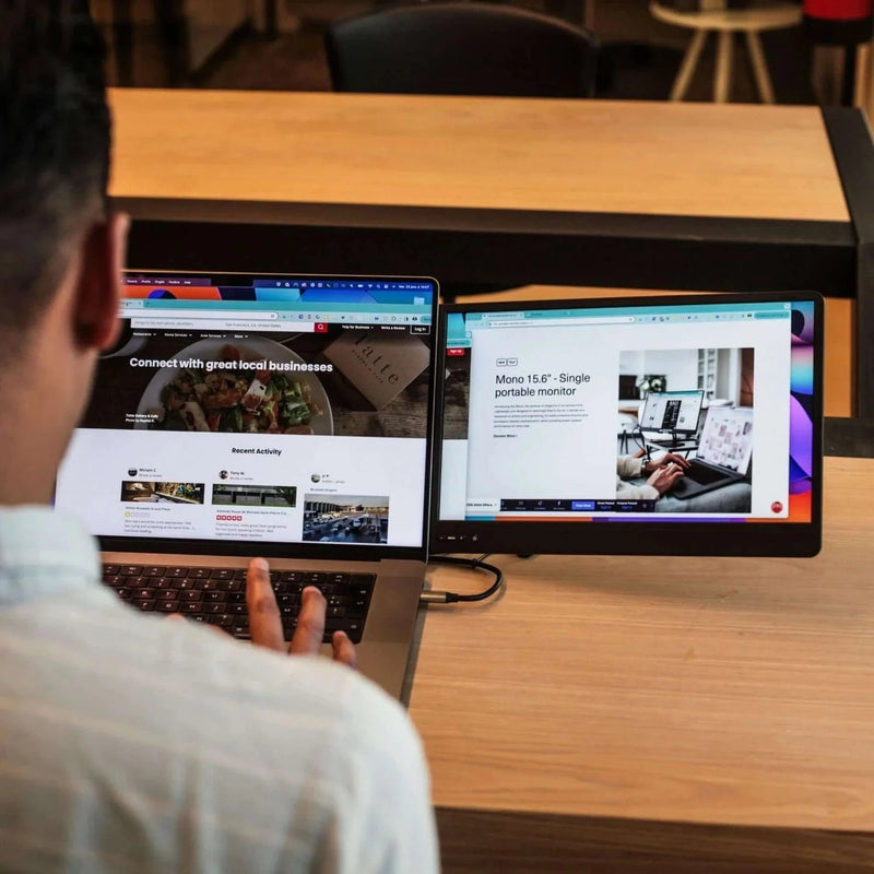 User working at a desk with a 14.1-inch triple screen portable monitor, using three extended displays to increase productivity and workflow efficiency