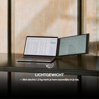 Lightweight portable monitor attached beside a laptop on a shelf, creating a dual-screen workspace while remaining compact for travel.