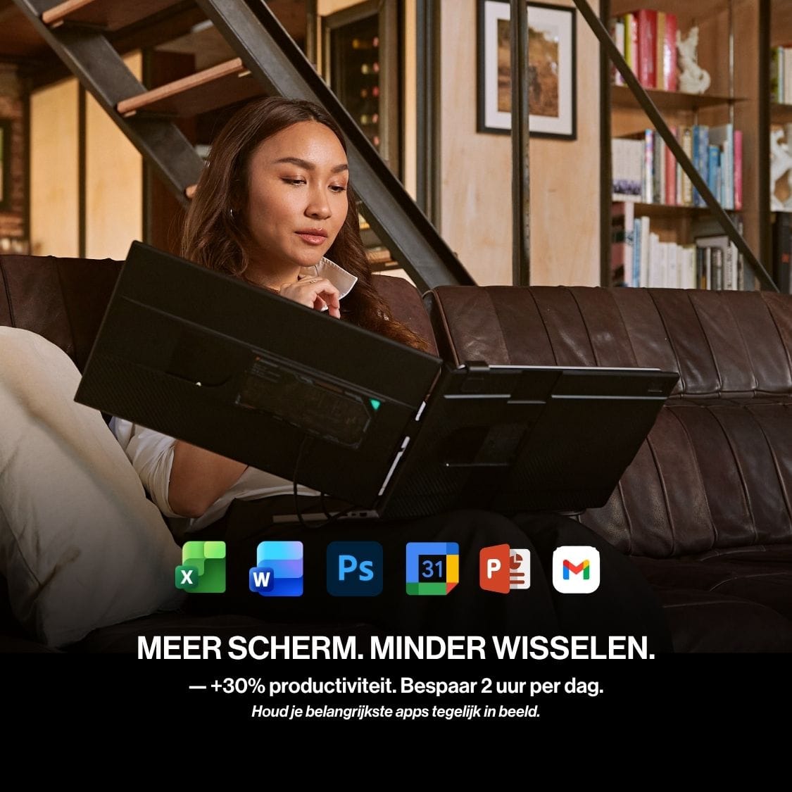 Person working from a sofa with a portable monitor attached to a laptop, providing extra screen space for several productivity apps at once.