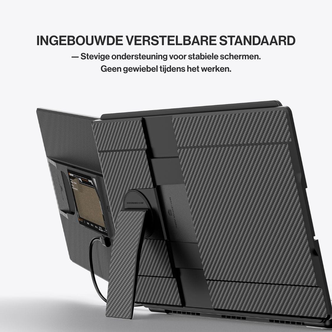Rear close-up of a portable monitor with textured housing and adjustable built-in stand supporting the screen securely beside a laptop.