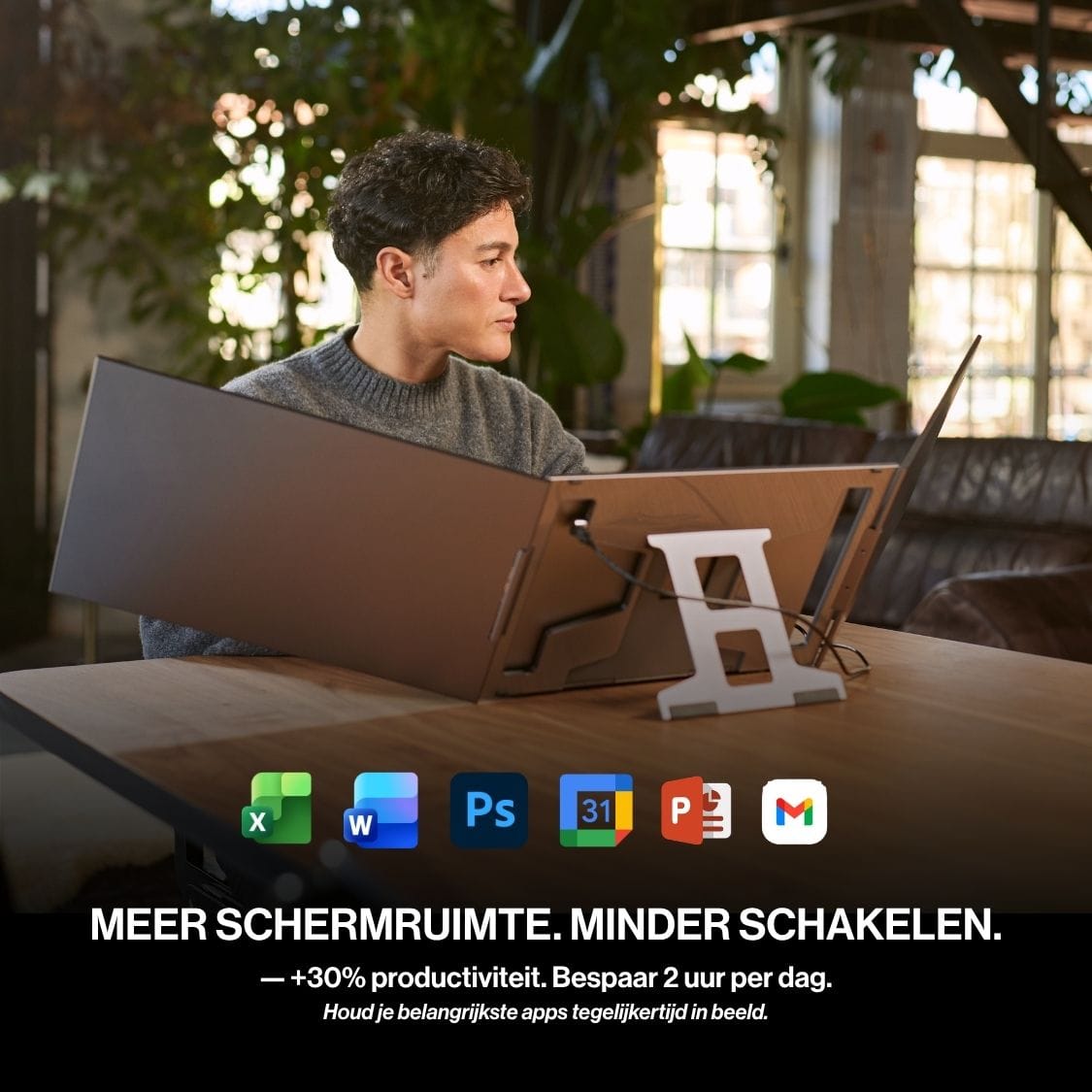 Person using a Portable monitor with two additional laptop screens for productivity across email, documents, calendars and creative applications.