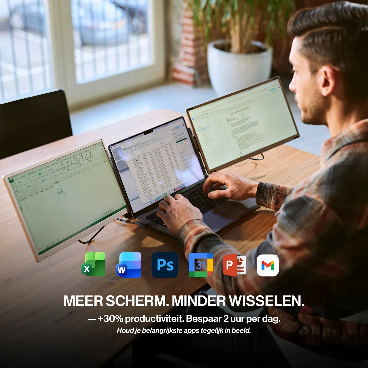 Man using a triple-screen portable monitor workspace with Excel, documents, and other productivity apps visible across multiple displays.