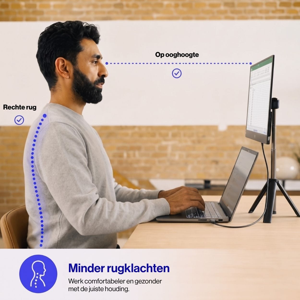Portable monitor raised to eye level on a tripod beside a laptop while a person sits upright, illustrating an ergonomic workspace designed for better posture.