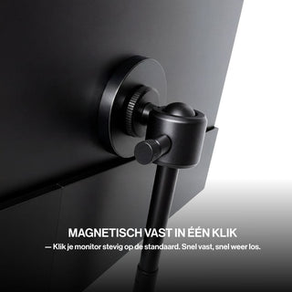 Close-up of a portable monitor securely connected to a tripod stand using a circular magnetic mounting system with an adjustable locking joint.