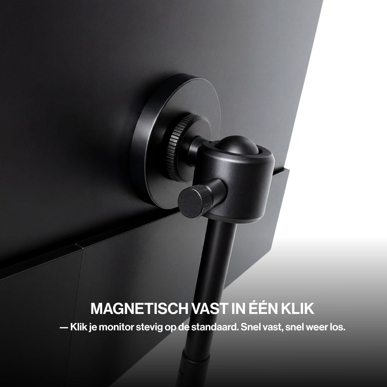 Close-up of a portable monitor securely connected to a tripod stand using a circular magnetic mounting system with an adjustable locking joint.