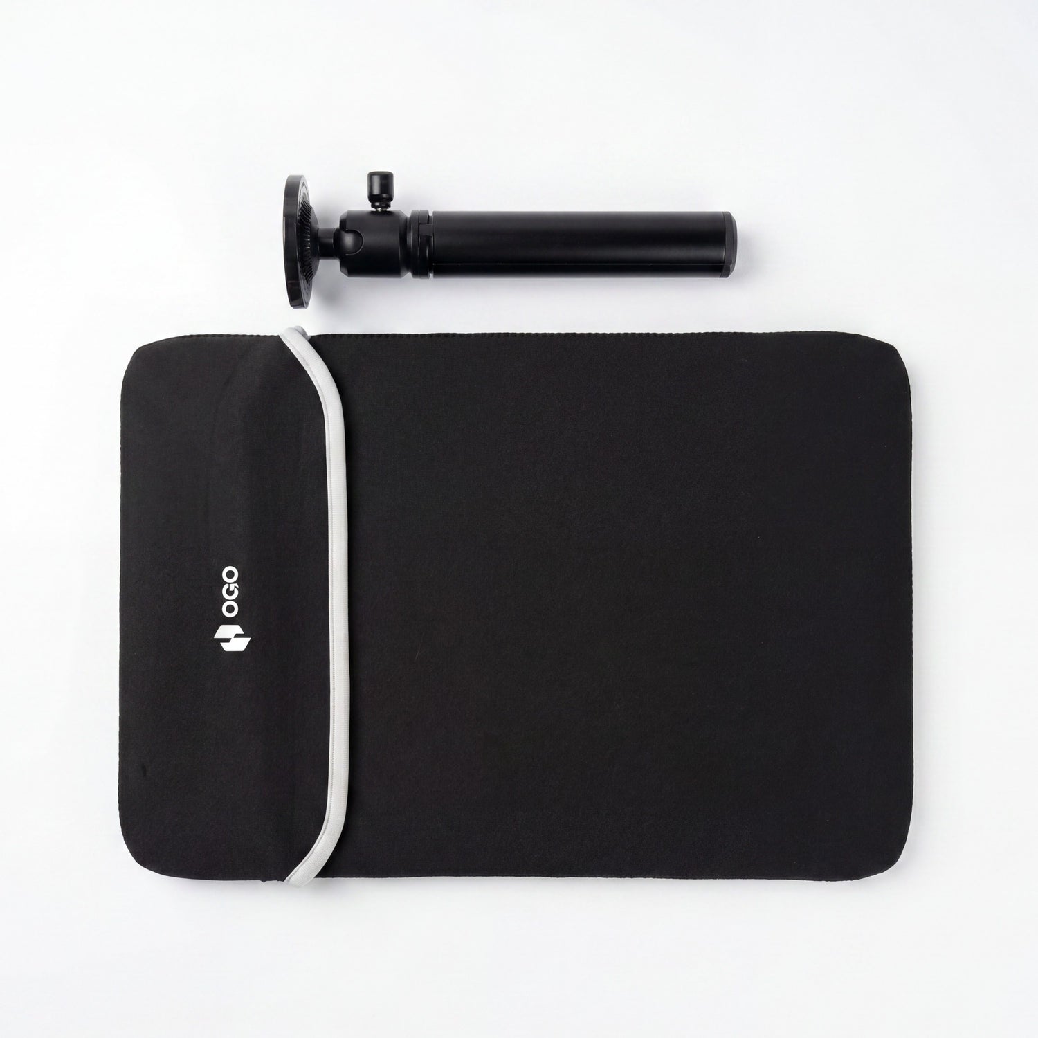 Portable monitor accessories flat lay with a black OGO carrying sleeve, white strap, and adjustable black tripod mount on a white background.