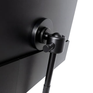 Portable monitor close-up showing the black adjustable ball-joint mount attached to the back of the screen for flexible positioning.