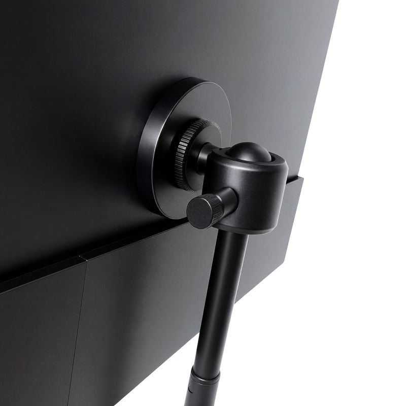 Portable monitor close-up showing the black adjustable ball-joint mount attached to the back of the screen for flexible positioning.