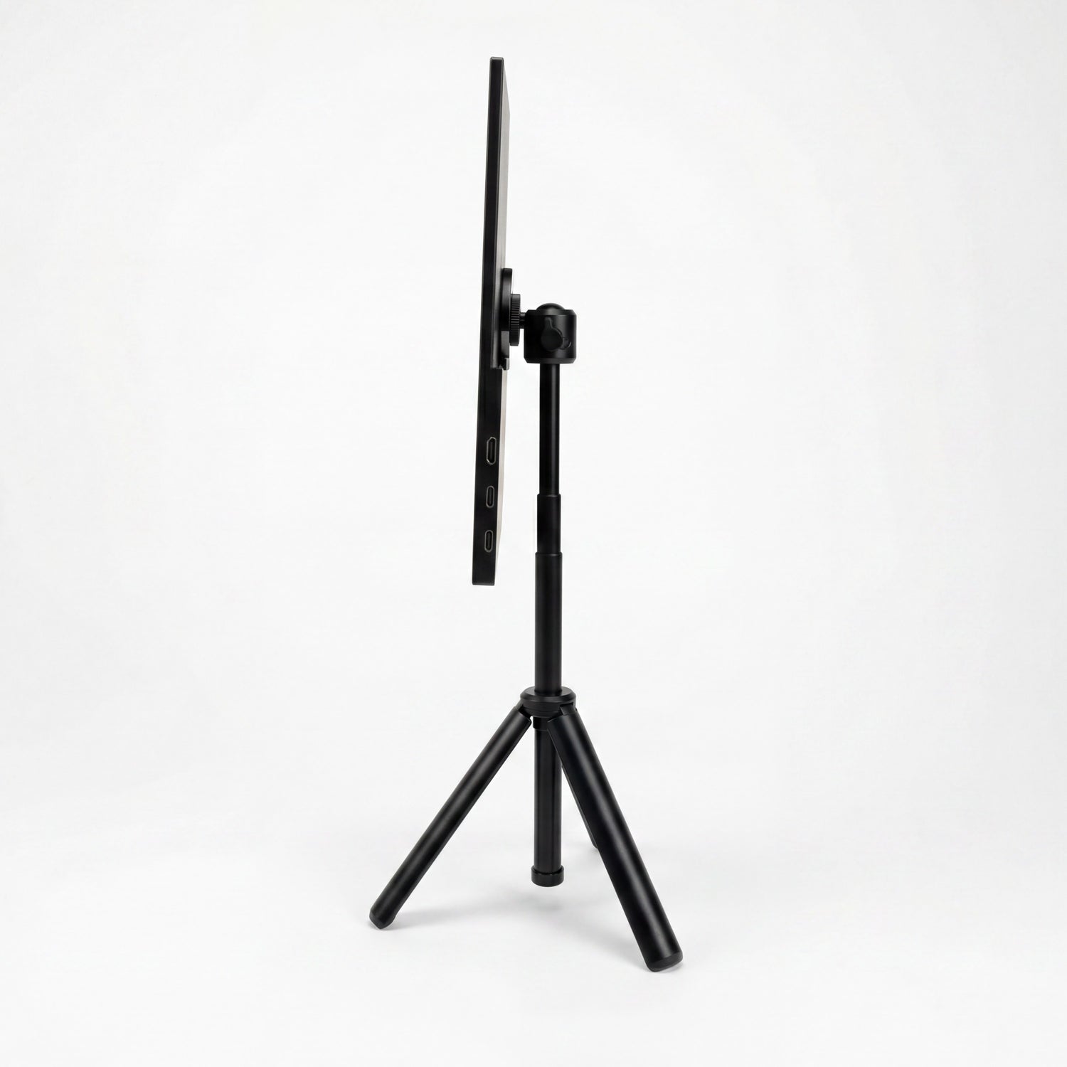 Portable monitor side view on a tripod stand, showing its thin profile, adjustable mount, and side connection ports.